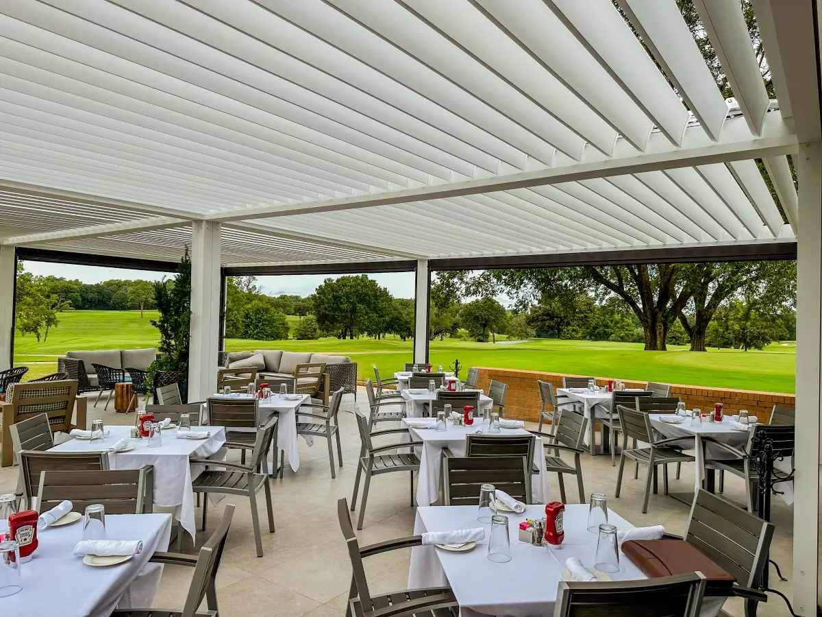 Alba louvered roof blades angled open over an outdoor dining area