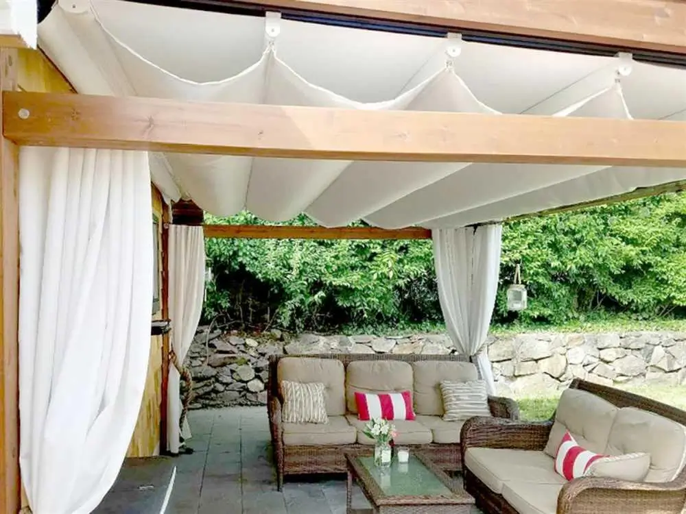 Corradi faux ceiling draped under a retractable pergola