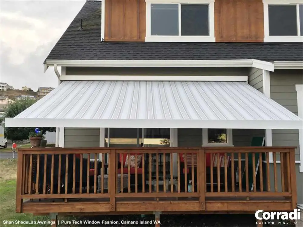 Motorized retractable awning extended over a raised deck